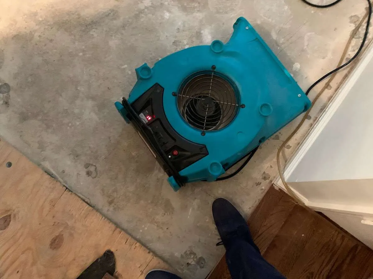 Air mover drying subfloor during Leak Detection & Repair in Lynn